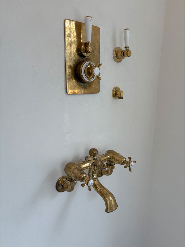 Plaster around shower controls after repair